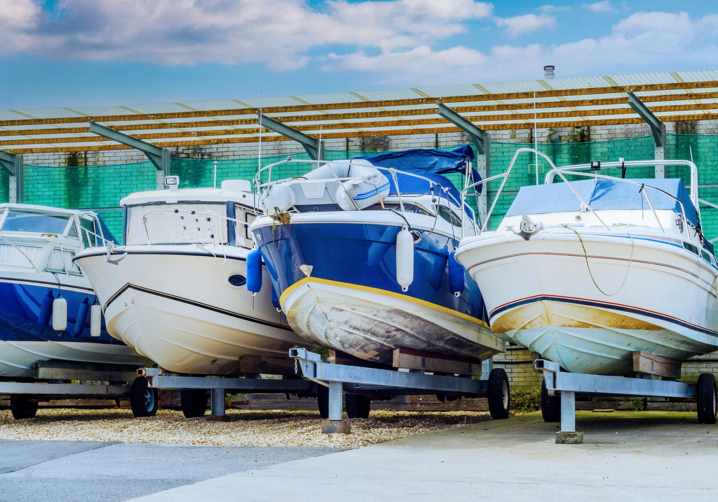 Boat on stand on the shore, close up on the part of the yacht, luxury ship, maintenance and parking place boat, marine industrial